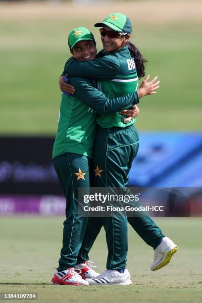 Ghulam Fatima and Bismah Maroof of Pakistan celebrate after taking the wicket of Mignon du Preez of South Africa during the 2022 ICC Women's Cricket...