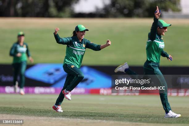 Ghulam Fatima and Bismah Maroof of Pakistan celebrate after taking the wicket of Mignon du Preez of South Africa during the 2022 ICC Women's Cricket...