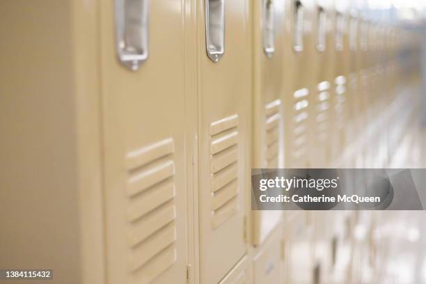 diminishing perspective of row of traditional metal school lockers - 中学校 ストックフォトと画像