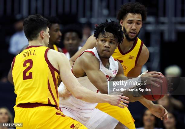 Terrence Shannon Jr. #1 of the Texas Tech Red Raiders controls the ball as Caleb Grill and George Conditt IV of the Iowa State Cyclones defend during...