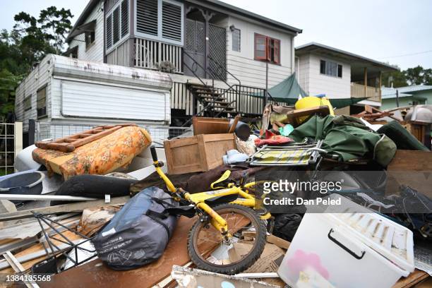 Flood-damaged items and debris are seen outside a house on March 11, 2022 in Murwillumbah, Australia. Residents across the NSW Northern Rivers areas...