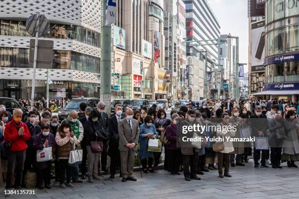 People gather for a minute of silence at 14:46, the time that the 2011 Tohoku earthquake hit, in the Ginza district on March 11, 2022 in Tokyo,...