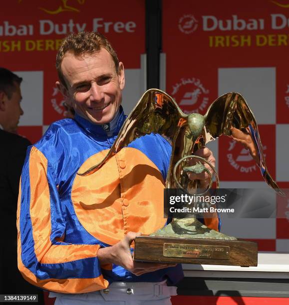 Kildare , Ireland - 2 July 2023; Jockey Ryan Moore celebrates with the trophy after winning the Dubai Duty Free Irish Derby on Auguste Rodin during...