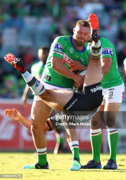 Dale Finucane of the Sharks tackles Elliot Whitehead of the Raiders during the round one NRL match between the Canberra Raiders and the Cronulla...
