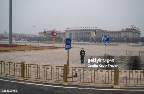 Police officer stands guard in Tiananmen Square before the closing session of the National People's Congress at the Great Hall of the People on March...