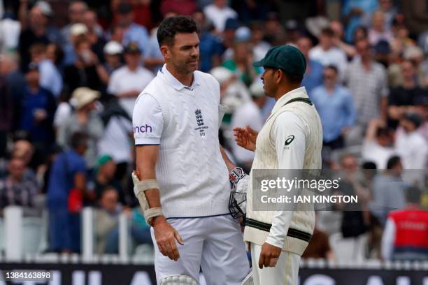 England's James Anderson and Australia's Usman Khawaja chat after Australia win on day five of the second Ashes cricket Test match between England...