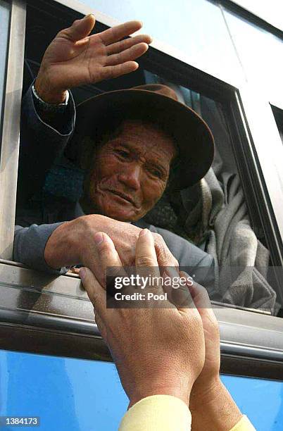 North Korean holds hands of his separated relative after the 5th reunion meeting of the separated family members between the two Koreas September 15,...