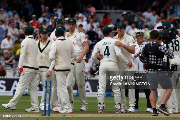 Australia's players celebrate on the field after they win on day five of the second Ashes cricket Test match between England and Australia at Lord's...