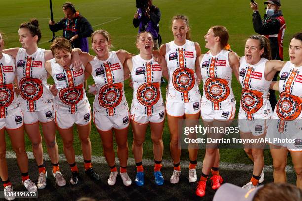 Ginats players sing the team song after during the round 10 AFLW match between the Geelong Cats and the Greater Western Sydney Giants at GMHBA...