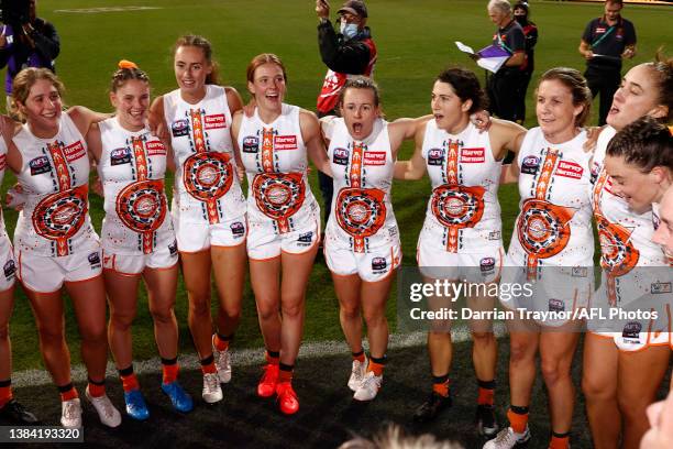 Ginats players sing the team song after during the round 10 AFLW match between the Geelong Cats and the Greater Western Sydney Giants at GMHBA...