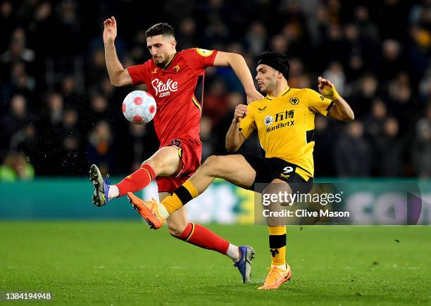 Craig Cathcart of Watford is challenged by Raul Jimenez of Wolverhampton Wanderers during the Premier League match between Wolverhampton Wanderers...