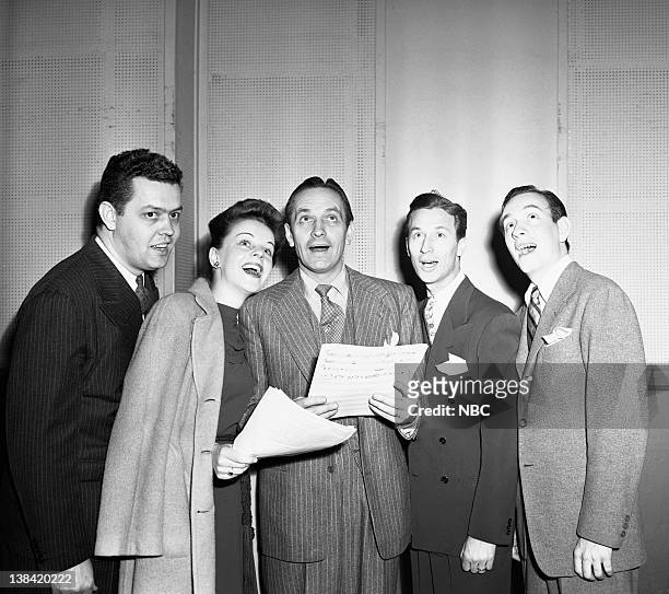 Salute to War Workers" -- Pictured: Musical group Hi-Lo Jack and the Dame host Fredric March, during a War Manpower Commission sponsored broadcast to...