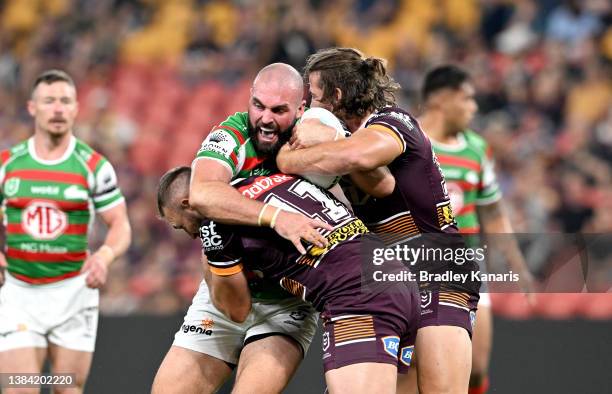 Mark Nicholls of the Rabbitohs takes on the defence during the round one NRL match between the Brisbane Broncos and the South Sydney Rabbitohs at...