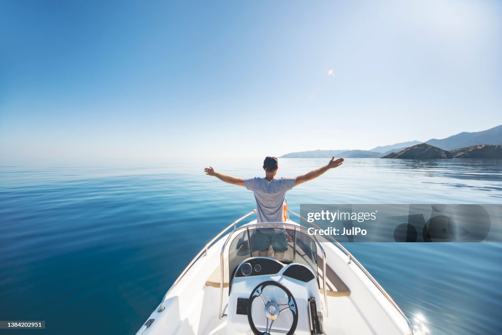 Young man riding on speedboat