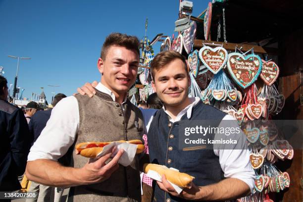people at oktoberfest in munich, germany - duitse cultuur stockfoto's en -beelden
