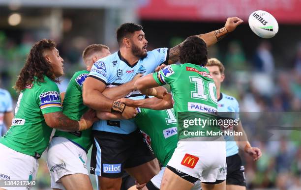 Royce Gunt of the Sharks offloads during the round one NRL match between the Canberra Raiders and the Cronulla Sharks at GIO Stadium, on March 11 in...