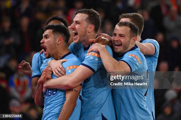 Bruno Guimaraes of Newcastle United celebrates with team mates Chris Wood and Ryan Fraser after scoring during the Premier League match between...