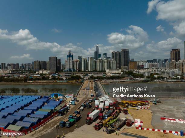 General view of a construction site of a temporary isolation facility to house Covid-19 patients is built next to a temporary bridge linking Shenzhen...