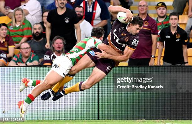 Corey Oates of the Broncos dives over to score a try during the round one NRL match between the Brisbane Broncos and the South Sydney Rabbitohs at...