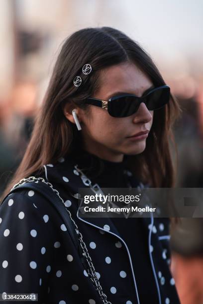 Alizee Gamberini is seen wearing a black and white suit with dots, a black LV mini bag, black sunglasses, a black turtleneck, a golden bracelet and...