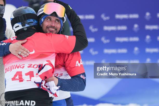 March 11:Ollie Hill of Team Great Britain and Matti Suur-Hamari of team Finland cerebration for the Men's Snowboard Banked Slalom SB-LL2 after the...