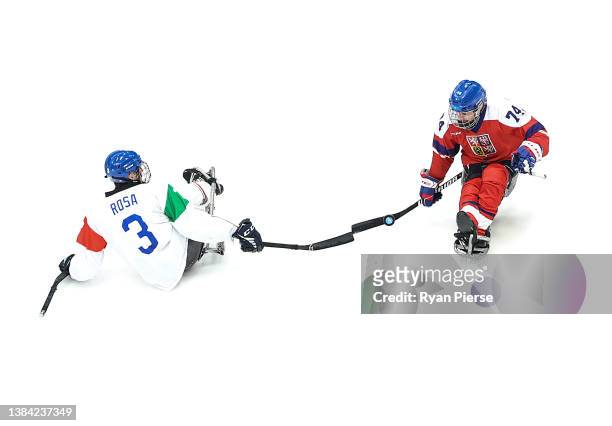 Gianluigi Rosa of Team Italy competes for the puck against Michal Geier of Team Czech Republic during the Para Ice Hockey 5th v 6th match between...