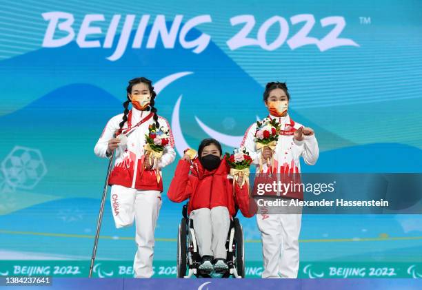 Silver medalist Sitong Liu of Team China, Gold medalist Momoka Muraoka of Team Japan and Bronze medalist Wenjing Zhang of Team China celebrate on the...