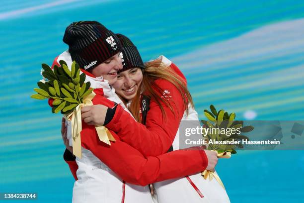 Bronze medalists Barbara Aigner and Klara Sykora of Team Austria celebrate on the podium during the medal ceremony for the Women's Giant Slalom...