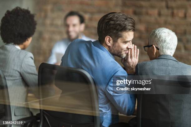 whispering on a job interview! - secret imagens e fotografias de stock