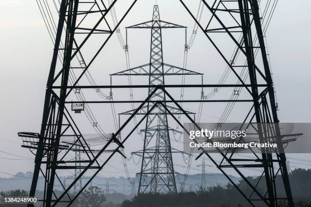 electricity pylons in the english countryside - electricity pylon stock pictures, royalty-free photos & images