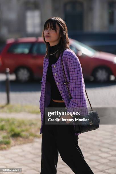 Sarah Ellen seen wearing a silver large chain necklace from Chanel, a black ribbed turtleneck cropped pullover, a purple with black checkered print...