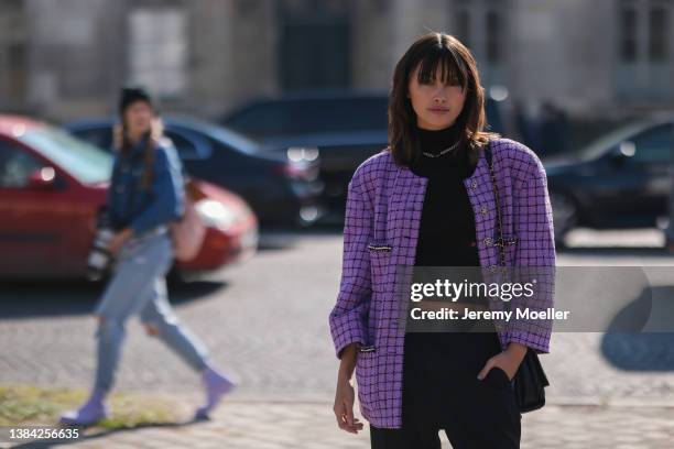 Sarah Ellen seen wearing a silver large chain necklace from Chanel, a black ribbed turtleneck cropped pullover, a purple with black checkered print...