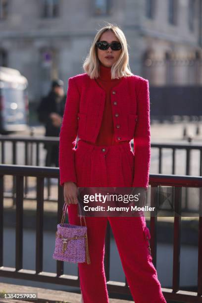 Candela Pelizza seen wearing a black sunglasses, a red turtleneck knit pullover, a red cropped tweed jacket from Chanel, matching red tweed wide leg...