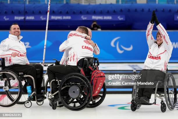 Dennis Thiessen, Ina Forest, Mark Ideson, and Jon Thurston of Team Canada celebrate defeating Team Slovakia in the Wheelchair Curling Bronze Medal...