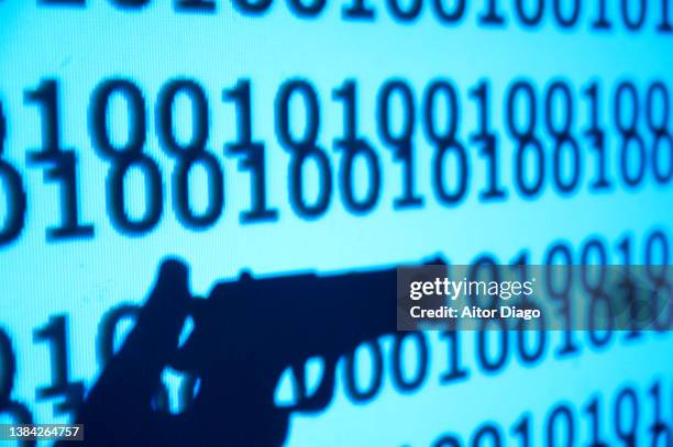 silhouette someone holding a gun. secret programming code close to it. - anfallsspel bildbanksfoton och bilder