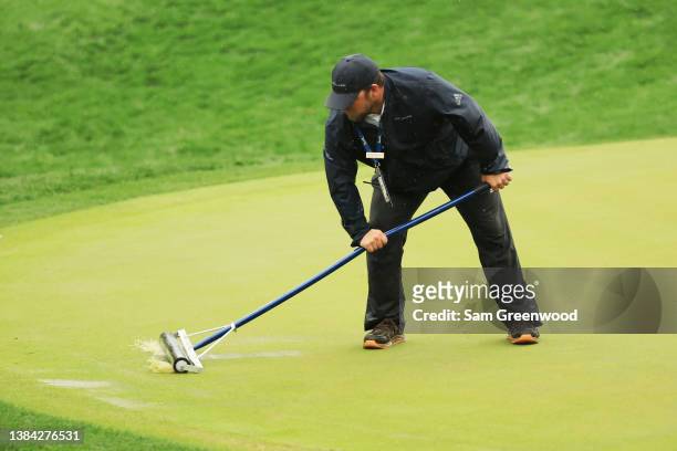 Assistant Superintendent, John Michael Clark, tends to water on a green during the continuation of the first round of THE PLAYERS Championship on the...