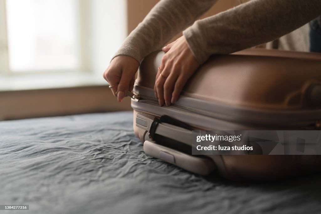 Woman packing a suitcase for a trip