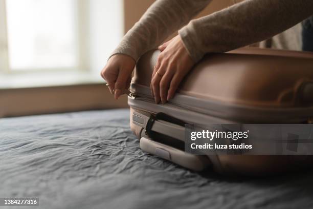 woman packing a suitcase for a trip - blixtlås bildbanksfoton och bilder