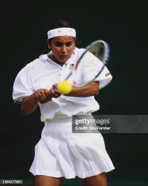 Jasmine Choudhury from Great Britain plays a double handed forehand return against Akiko Morigami of Japan during their Junior Girls Singles First...