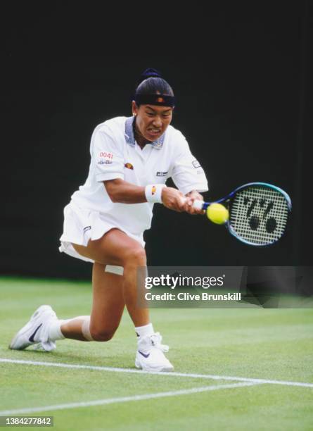 Kimiko Date from Japan plays a double handed forehand return against Mary Pierce of France during their Women's Singles First Round match at the...