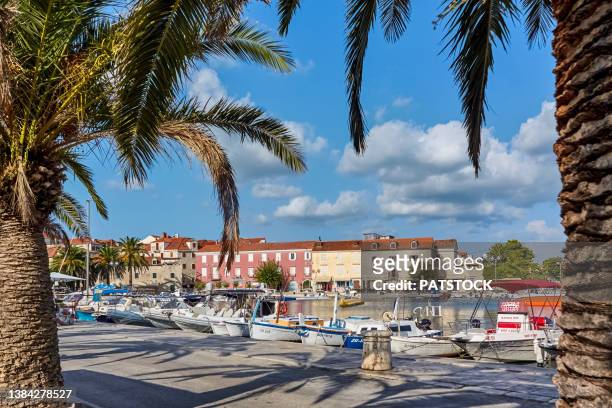 fishing boats moored by the harbor in supetar, brac island, croatia - brac island stock pictures, royalty-free photos & images