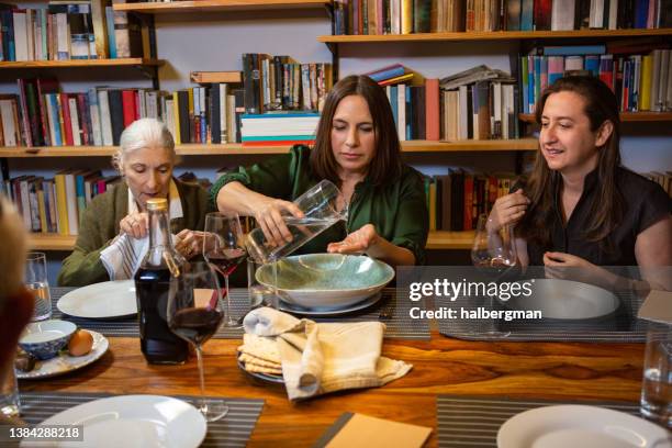 women washing hands at passover seder - passover stockfoto's en -beelden