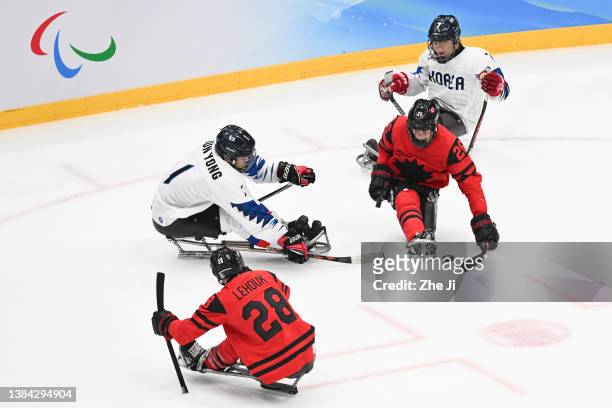 Anton Jacobs-Webb of Team Canada and Yong LeeJun of Team South Korea of compete for the puck in the third period during the Para Ice Hockey...