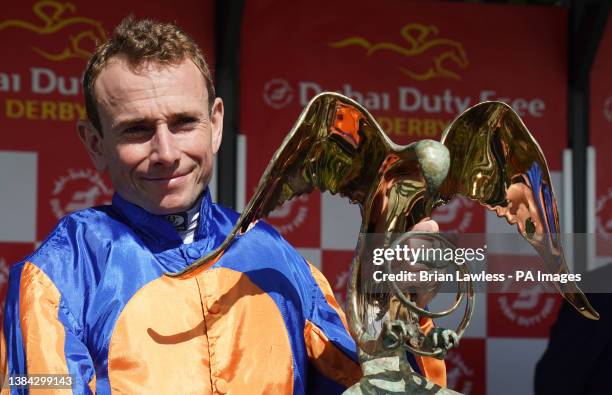 Jockey Ryan Moore with the trophy after winning the Dubai Duty Free Irish Derby on Auguste Rodin during day three of the Dubai Duty Free Irish Derby...