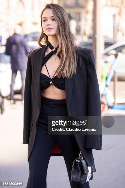 Valeria Lipovetsky wearing a black Chanel crop top, black trousers, black blazer and black and white Chanel bag, is seen outside Chanel, during Paris...