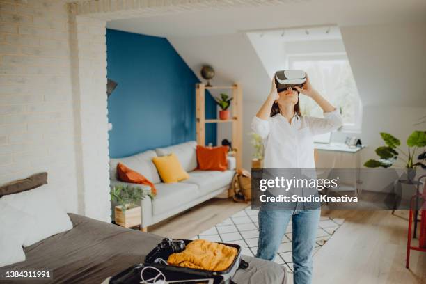 young woman packing her suitcase for a trip - virtual visit stock pictures, royalty-free photos & images