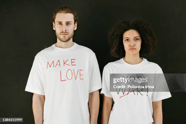 young people with slogans make love not war. - slogan t shirt fotografías e imágenes de stock