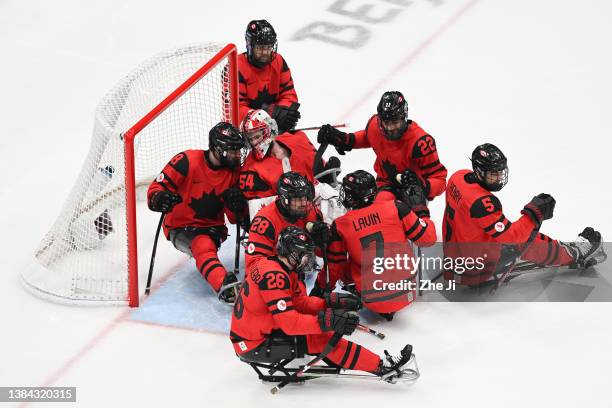 Team Canada celebrates the win against Team South Korea during the Para Ice Hockey semifinals on day seven of the Beijing 2022 Winter Paralympics at...