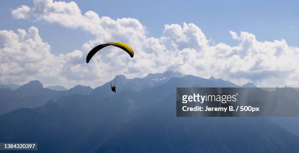 jaman - montreux - suisse,low angle view of person paragliding against sky,montreux,switzerland - high up stock-fotos und bilder