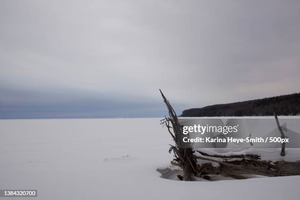 frozen landscape,scenic view of snow covered land against sky,pictured rocks national lakeshore,united states,usa - pictured rocks in winter stock pictures, royalty-free photos & images